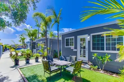 a patio with a table and chairs in front of a house at Pacific Beach Cottage 3 Walk to the Beach and Bay in San Diego