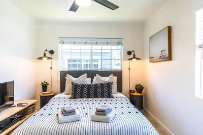 a bedroom with a large bed with two pillows at Pacific Beach Cottage 4 Walk to the Beach and Bay in San Diego