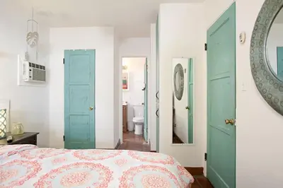 a bedroom with green doors and a bed and a mirror at Old Town 1BR Short Drive to Downtown and Beaches 2.5 in San Diego