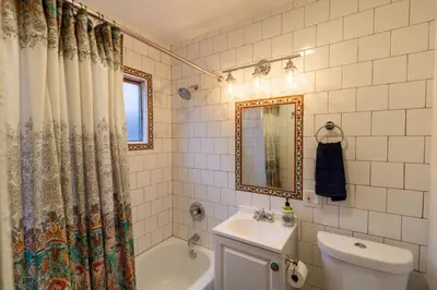 a bathroom with a shower curtain and a toilet and a sink at Old Town 1BR Short Drive to Downtown and Beaches 2.5 in San Diego