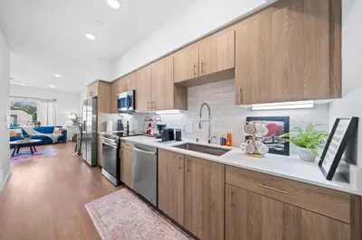 a kitchen with wooden cabinets and a counter top at Stylish Top-Floor Gem with King Bed & City Ocean Views in San Diego