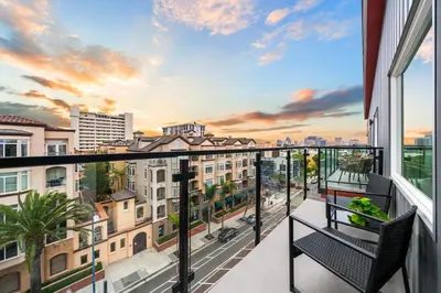 a balcony with two chairs and a view of a city at Stylish Top-Floor Gem with King Bed & City Ocean Views in San Diego