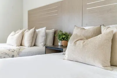 a bedroom with two beds with white pillows at ERTH INN by AGA- San Ysidro in San Diego