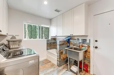 a kitchen with white cabinets and a sink at 2 Mi to Lake Poway Mtn-View Escape with Patio! in Poway