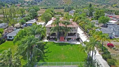 an aerial view of a house with palm trees at Lakeside Mansion Waterfront 34 beds Boat ramp in Lake Elsinore