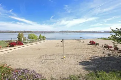 a beach with a view of a body of water at Lakeside Mansion Waterfront 34 beds Boat ramp in Lake Elsinore