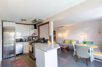 a kitchen and living room with a counter and a table at Ocean Beach Bungalow Separate Entry in San Diego