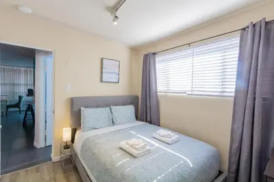 a bedroom with a bed with towels on it at Ocean Beach Bungalow Separate Entry in San Diego