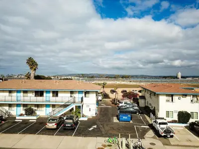 a parking lot with cars parked in front of a building at Ocean Beach Bungalow Separate Entry in San Diego