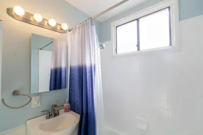 a bathroom with a sink and a window at Ocean Beach Bungalow Separate Entry in San Diego