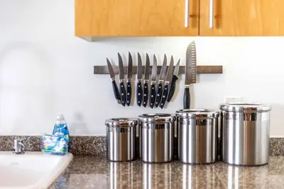 a kitchen counter with several silver canisters and a knife rack at Modern Loft, Quiet, WiFi, Cable, Parking in San Diego