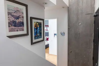 a staircase in a house with two pictures on the wall at Modern Loft, Quiet, WiFi, Cable, Parking in San Diego