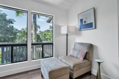 a living room with a chair and large windows at Upscale 4BR Retreat near Monserate Winery Pool Spa in Fallbrook