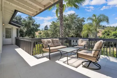 a patio with two chairs and a table on a balcony at Upscale 4BR Retreat near Monserate Winery Pool Spa in Fallbrook