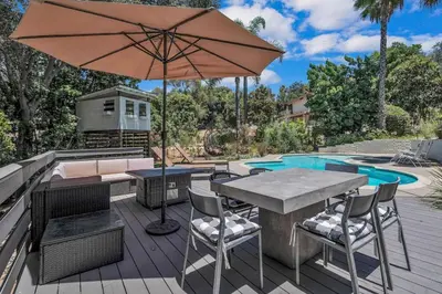 a patio with an umbrella and a table and chairs at Upscale 4BR Retreat near Monserate Winery Pool Spa in Fallbrook