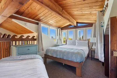 a bedroom with two beds and a wooden ceiling at The Whalen House - Steps from the Ocean in San Diego