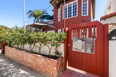 a red door on the side of a building at The Whalen House - Steps from the Ocean in San Diego
