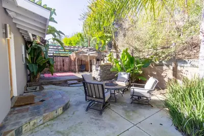 a patio with a table and chairs and a fence at Centrally Located Cottage Near Lake Trails Shops in La Mesa