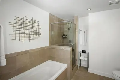 a bathroom with a tub and a shower and a toilet at Panoramic Bay and City Views - 2BR, Pool, Gym, Parking in San Diego