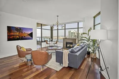 a living room with a couch and a fireplace at Panoramic Bay and City Views - 2BR, Pool, Gym, Parking in San Diego