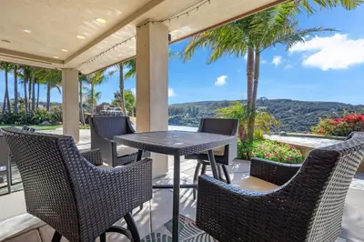 a table and chairs on a porch with a view at Hilltop Del Mar Lux Infinity Pool Panoramic Views in San Diego