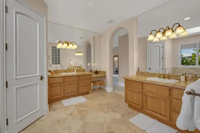 a large bathroom with two sinks and two mirrors at Hilltop Del Mar Lux Infinity Pool Panoramic Views in San Diego