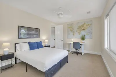 a bedroom with a large bed and a map on the wall at Hilltop Del Mar Lux Infinity Pool Panoramic Views in San Diego