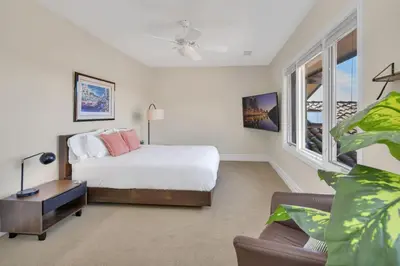 a bedroom with a bed and a couch and windows at Hilltop Del Mar Lux Infinity Pool Panoramic Views in San Diego