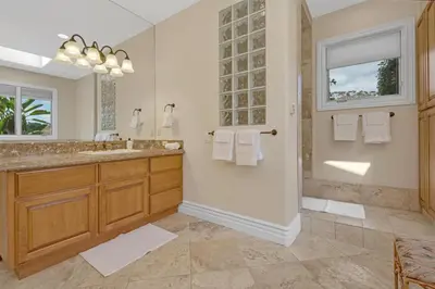 a bathroom with a double sink and a shower at Hilltop Del Mar Lux Infinity Pool Panoramic Views in San Diego