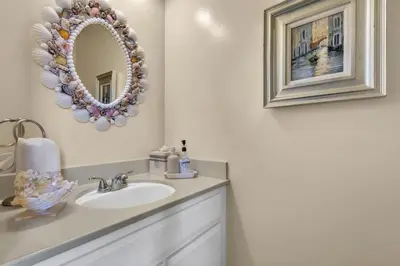 a bathroom with a sink and a mirror at 2BR Condo with Views Near Shops and Food, Fast WiFi in Carlsbad