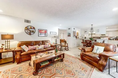 a living room with leather couches and a table at 2 Mi to Galleta Meadows Desert Golf Retreat! in Borrego Springs