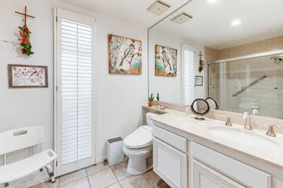 a white bathroom with a sink and a toilet at 2 Mi to Galleta Meadows Desert Golf Retreat! in Borrego Springs