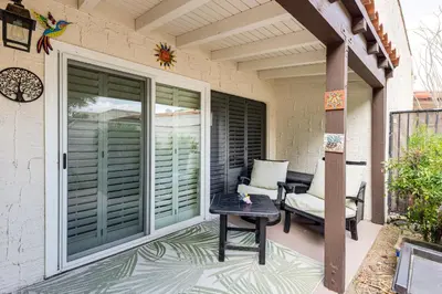a patio with sliding glass doors and a table at 2 Mi to Galleta Meadows Desert Golf Retreat! in Borrego Springs