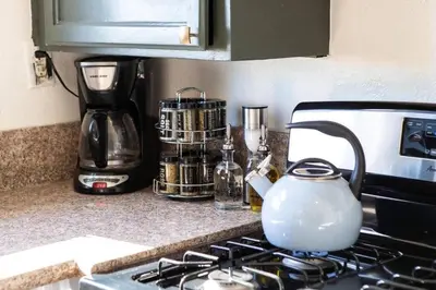 a tea kettle sitting on top of a stove in a kitchen at Victorian Gem Close to Petco Park & Gaslamp in San Diego
