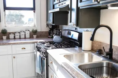 a kitchen with a sink and a stove top oven at Victorian Gem Close to Petco Park & Gaslamp in San Diego