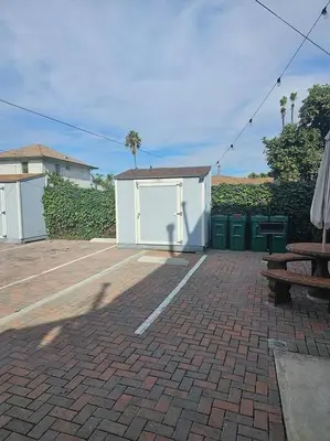 a brick patio with a white shed and a bench at Victorian Gem Close to Petco Park & Gaslamp in San Diego