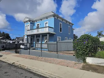 a blue house with a fence in front of it at Victorian Gem Close to Petco Park & Gaslamp in San Diego