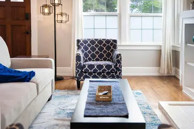 a living room with a couch and a chair at The Captain Quarters- Rosecrans Marina Escape in San Diego
