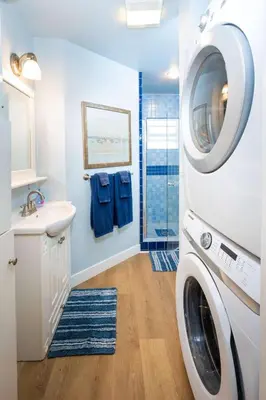 a washing machine in a bathroom with a sink and a washer at Steps from the Sand Mission Beach House in San Diego