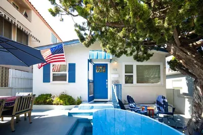 a house with an american flag on a patio at Steps from the Sand Mission Beach House in San Diego