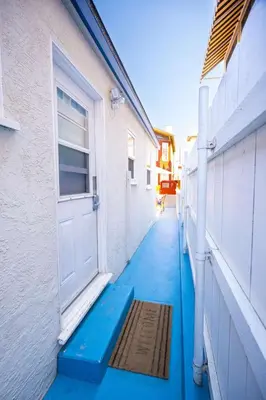 a hallway with a door and a mat in front of a building at Steps from the Sand Mission Beach House in San Diego