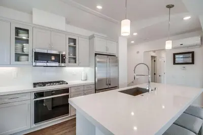 a kitchen with white cabinets and a white counter top at Bayside Cove 10 in San Diego
