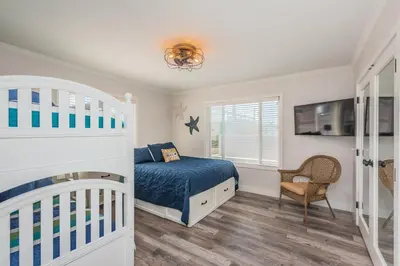 a bedroom with a bunk bed and a crib at Seaside Retreat in San Diego