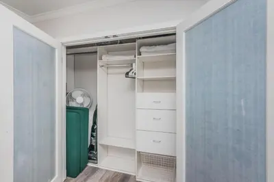 a closet with white drawers and a green door at Seaside Retreat in San Diego