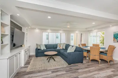 a living room with a blue couch and a table at Seaside Retreat in San Diego