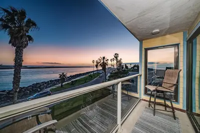 a house with a balcony with a view of the ocean at Ocean Vista Penthouse 2 in San Diego