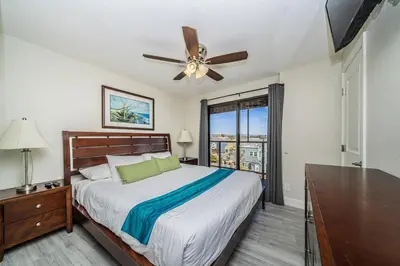 a bedroom with a bed and a ceiling fan at Ocean Vista Penthouse 1 in San Diego