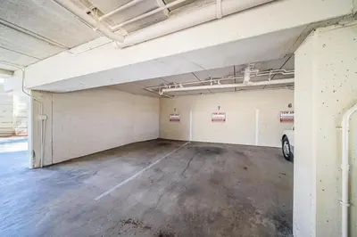 an empty parking garage with a car parked in it at Ocean Vista Penthouse 1 in San Diego