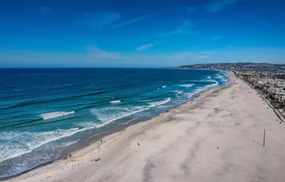 an aerial view of a beach with people on it at Ocean Vista Penthouse 1 in San Diego