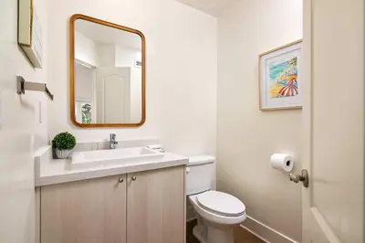 a bathroom with a sink and a toilet and a mirror at La Jolla Hillside Views and Coastal Comfort in San Diego